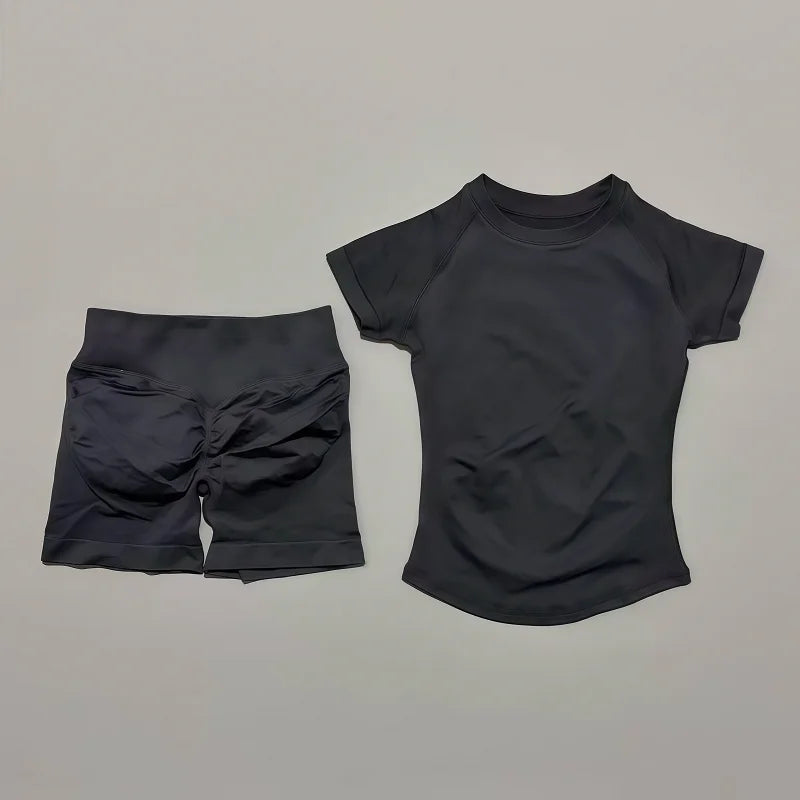 Women's seamless 2-piece workout set — short-sleeve top and high-waist scrunch shorts in Black